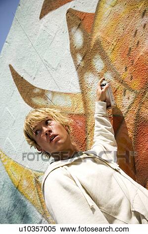 Portrait of a young man vandalising a wall with graffiti View Large Photo Image Stock Photography - Portrait of a young man vandalising a wall with graffiti . Fotosearch