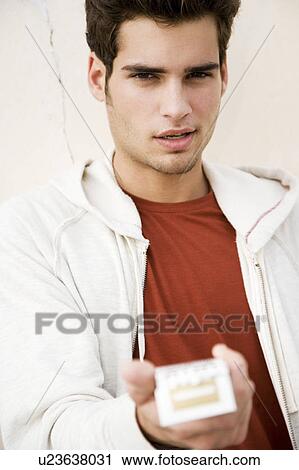 Portrait of a young man with cigarettes View Large Photo Image Stock Image - Portrait of a young man with cigarettes . Fotosearch