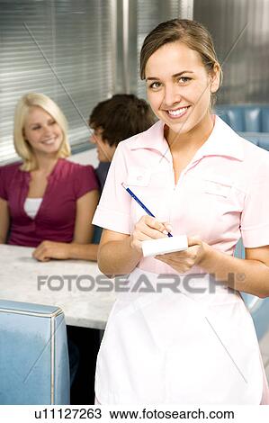 Stock Image - Diner waitress with an order pad and pen. Fotosearch
