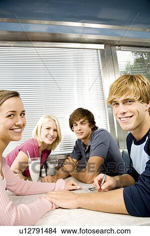 Picture - Friends hanging out in a diner . Fotosearch