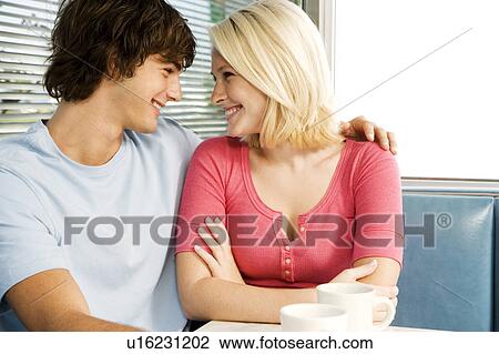 Portrait of a teenage couple flirting in a diner View Large Photo Image Stock Image - Portrait of a teenage couple flirting in a diner. Fotosearch