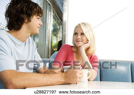 Portrait of a teenage couple flirting in a diner View Large Photo Image Stock Photo - Portrait of a teenage couple flirting in a diner. Fotosearch