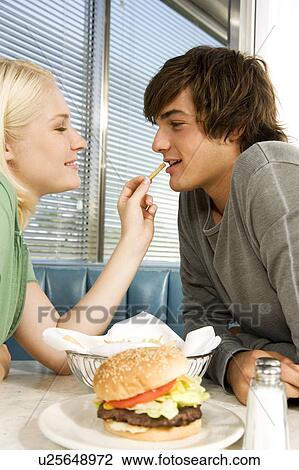 Teenage couple in a diner View Large Photo Image Stock Image - Teenage couple in a diner. Fotosearch