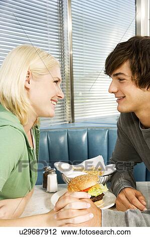 Teenage couple in a diner View Large Photo Image Stock Image - Teenage couple in a diner. Fotosearch