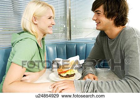 Stock Photo - Teenage couple in a diner. Fotosearch