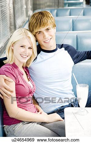 Stock Photo - Teenage couple sitting in a diner . Fotosearch