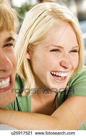 Young couple embracing, sitting in a diner View Large Photo Image Stock Image - Young couple embracing, sitting in a diner . Fotosearch