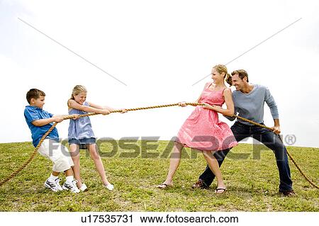 family of four playing tug of war View Large Photo Image Stock Image - family of four playing tug of war. Fotosearch