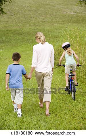 family walking and cycling in the countryside View Large Photo Image Stock Image - family walking and cycling in the countryside. Fotosearch