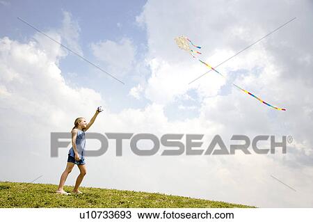 Stock Image - girl flying kite. Fotosearch