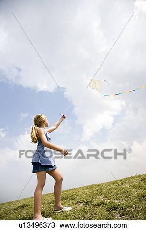 Stock Image - girl flying kite. Fotosearch
