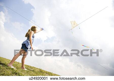 Stock Image - girl flying kite. Fotosearch