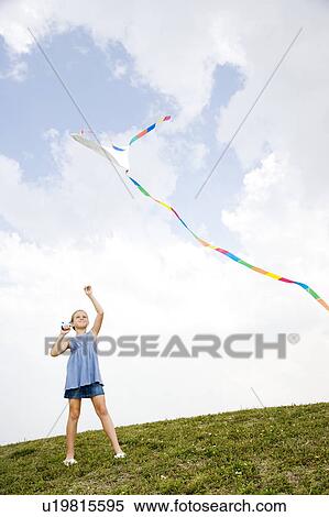 Stock Photography - girl flying kite. Fotosearch