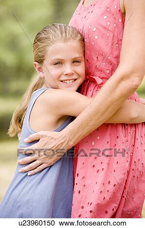 girl hugging woman around the waist View Large Photo Image Stock Image - girl hugging woman around the waist. Fotosearch