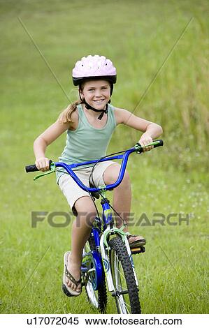 girl riding bicycle on the grass View Large Photo Image Stock Photography - girl riding bicycle on the grass. Fotosearch