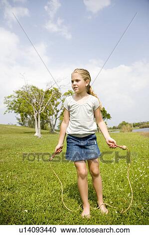 little girl playing with skipping rope View Large Photo Image Stock Image - little girl playing with skipping rope. Fotosearch