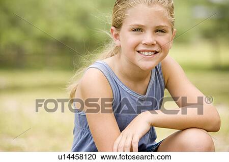 Stock Image - portrait girl resting arm on knee. Fotosearch