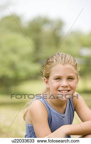 Stock Image - portrait girl resting arm on knee. Fotosearch