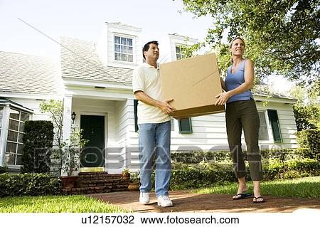 Couple moving into their new home View Large Photo Image Stock Image - Couple moving into their new home. Fotosearch