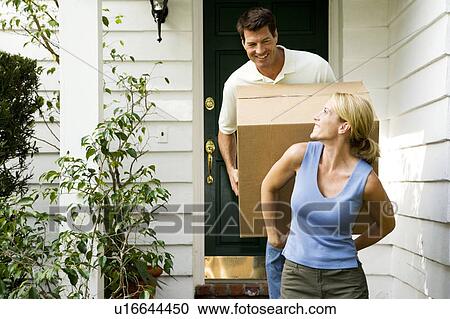 Couple moving into their new home View Large Photo Image Stock Image - Couple moving into their new home. Fotosearch