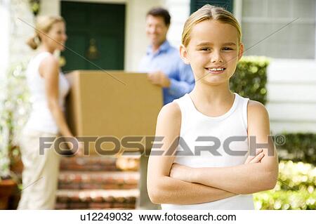 Stock Image - Family moving into their new home. Fotosearch