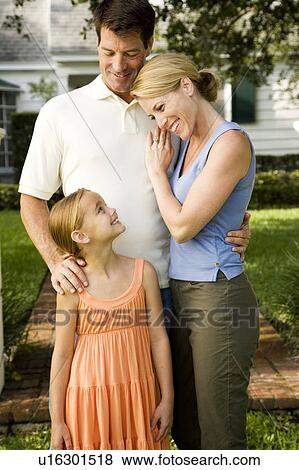 Family standing on the garden path outside their new home View Large Photo Image Stock Photo - Family standing on the garden path outside their new home. Fotosearch