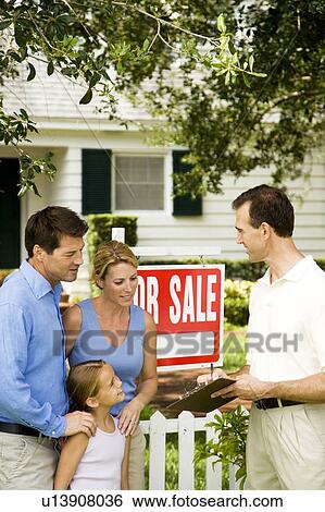 Family with estate agent outside property for sale View Large Photo Image Stock Photograph - Family with estate agent outside property for sale. Fotosearch