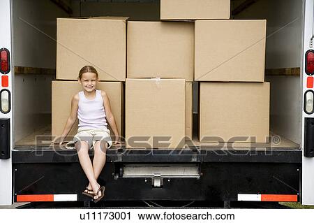 Little girl sitting with packing boxes in the removal van, moving home View Large Photo Image Stock Image - Little girl sitting with packing boxes in the removal van, moving home. Fotosearch