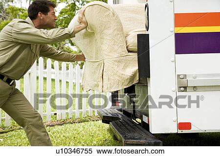 Stock Photography - Removal man loading or unloading sofa from his van. Fotosearch