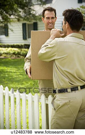 Removal men carrying packing boxes View Large Photo Image Stock Photo - Removal men carrying packing boxes. Fotosearch