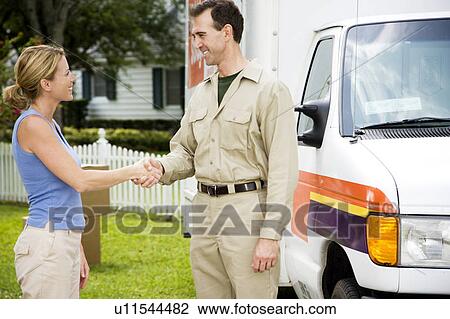 Woman shaking hands with removal man beside his van View Large Photo Image Stock Image - Woman shaking hands with removal man beside his van. Fotosearch