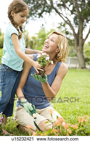daughter helping mother with the gardening View Large Photo Image Stock Image - daughter helping mother with the gardening. Fotosearch