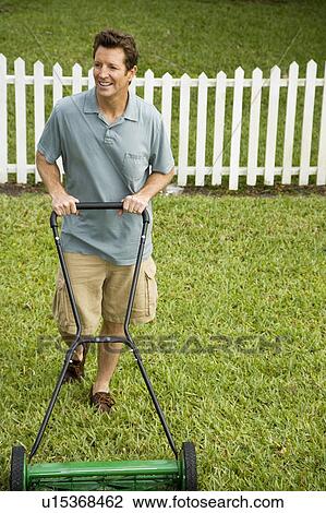 man mowing the lawn View Large Photo Image Stock Image - man mowing the lawn. Fotosearch