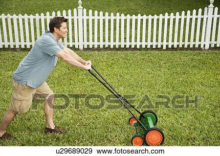 man mowing the lawnn View Large Photo Image Stock Photo - man mowing the lawnn. Fotosearch