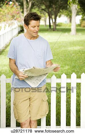 man reading paper in the garden View Large Photo Image Stock Photo - man reading paper in the garden. Fotosearch