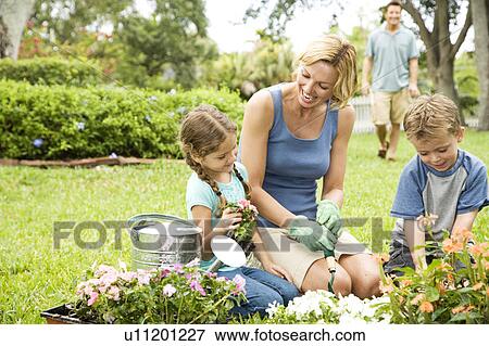 Stock Photo - mother and children gardening. Fotosearch
