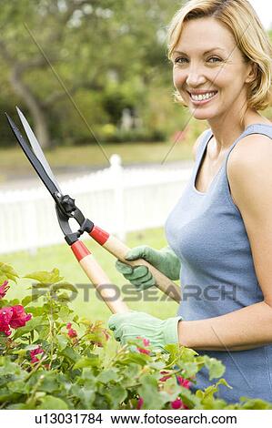 woman in the garden holding garden shears View Large Photo Image Picture - woman in the garden holding garden shears. Fotosearch