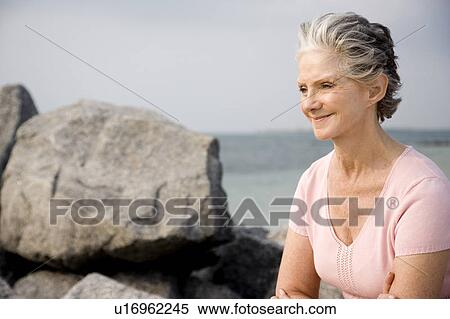 Stock Photography - Portrait of a senior woman at the beach . Fotosearch