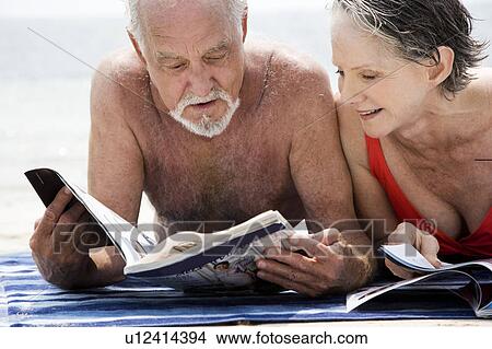 Picture - Senior couple relaxing at the beach . Fotosearch