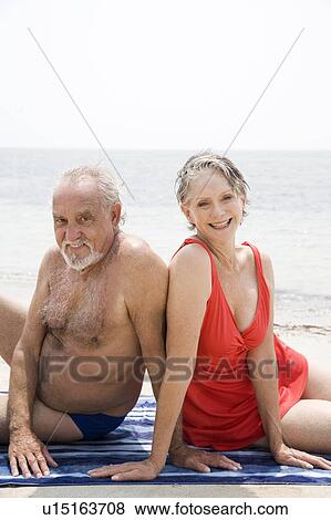 Senior couple relaxing at the beach View Large Photo Image Stock Photo - Senior couple relaxing at the beach . Fotosearch