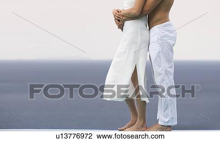 A couple embracing by a pool View Large Photo Image Stock Image - A couple embracing by a pool. Fotosearch