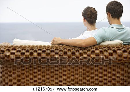 Stock Photo - A couple relaxing on a sofa . Fotosearch