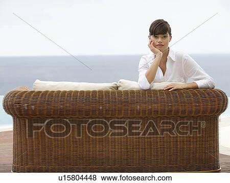 Stock Photo - A woman relaxing on a sofa. Fotosearch