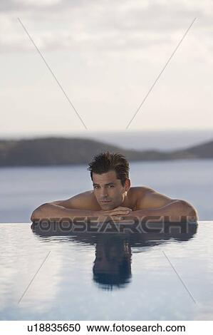 Stock Image - A man relaxing in a pool. Fotosearch
