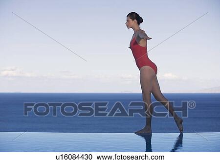 A woman dancing on the edge of a pool View Large Photo Image Stock Image - A woman dancing on the edge of a pool. Fotosearch
