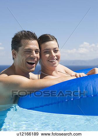 A couple relaxing in a pool View Large Photo Image Stock Photo - A couple relaxing in a pool. Fotosearch