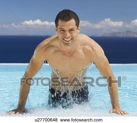 Stock Photo - A man emerging from a swimming pool. Fotosearch