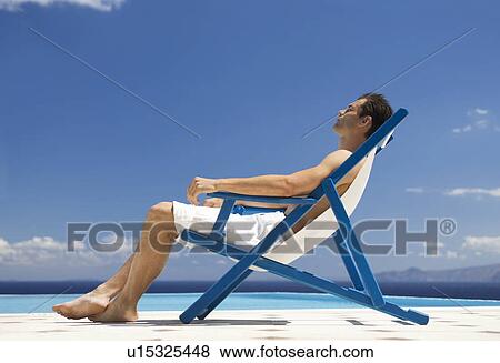 Stock Photo - A man relaxing in a deck chair. Fotosearch