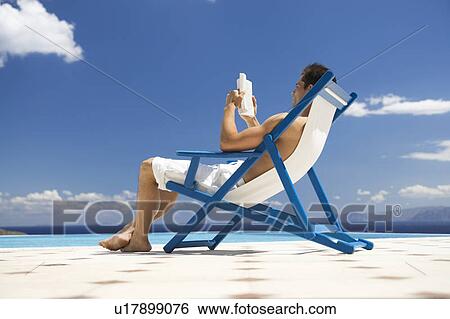 Stock Photograph - A man relaxing in a deck chair. Fotosearch