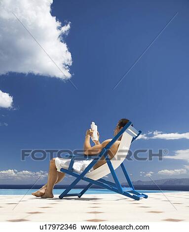 Stock Photograph - A man relaxing in a deck chair. Fotosearch